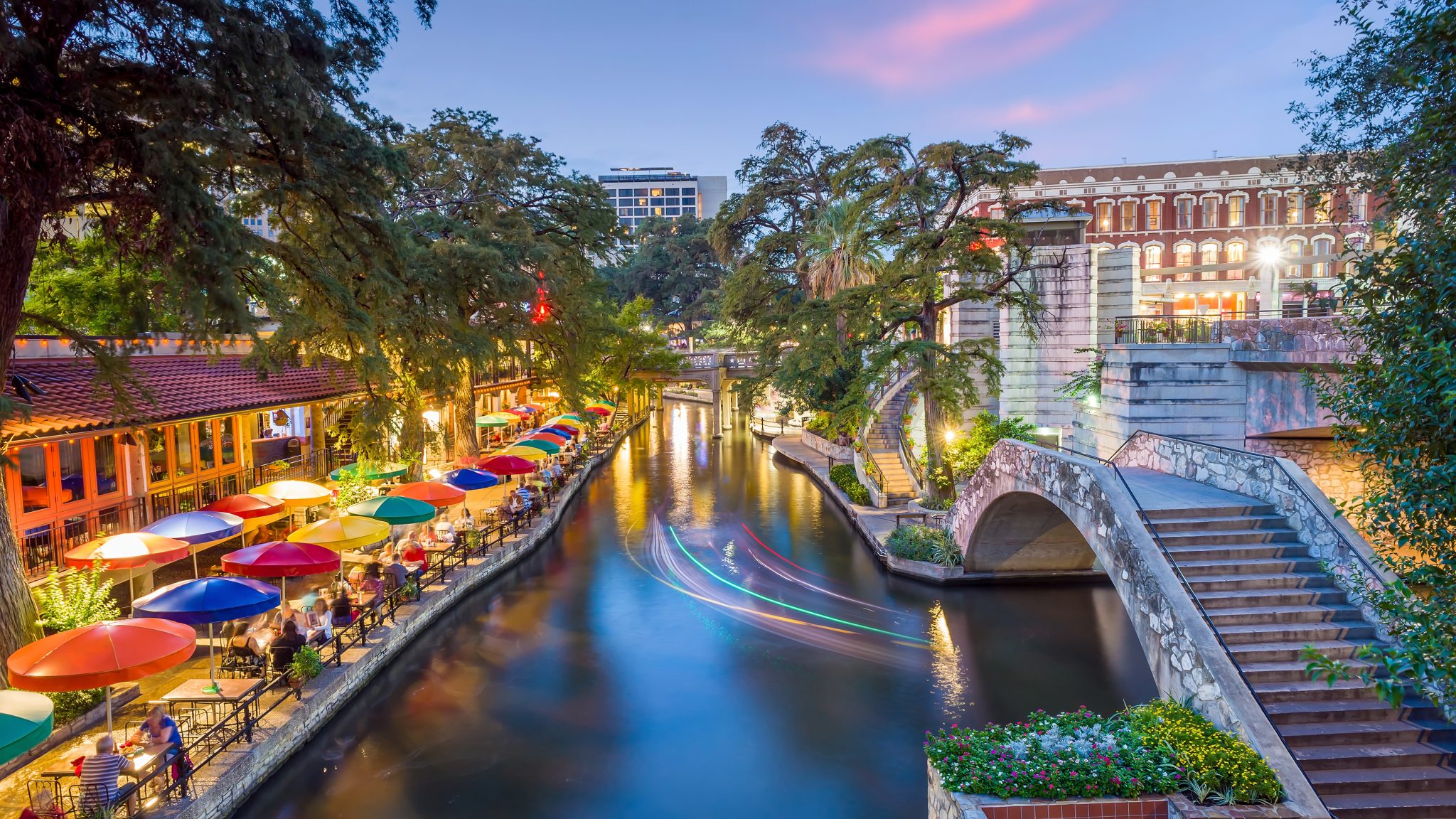 River walk in San Antonio city downtown skyline cityscape of Texas USA at sunset